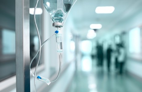 Drip bag in hospital corridor representing Healthcare associations